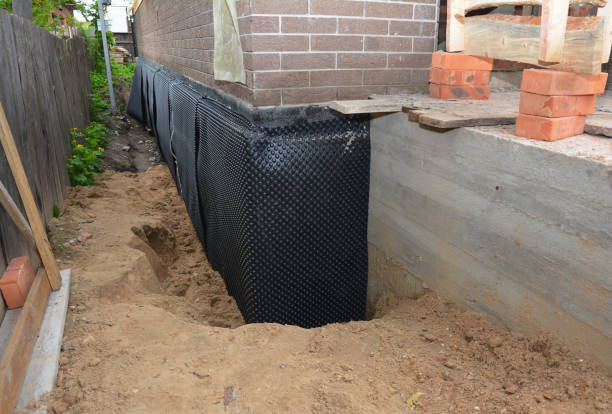 SJ Waterproofing Pros technician performing targeted Wet Basement Repair assessment in Heltonville, IN